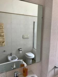 a bathroom with a sink and a toilet and a mirror at Villa Valentina in Taranto +18 photos