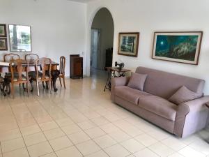 ein Wohnzimmer mit einem Sofa und einem Tisch in der Unterkunft Villa Valentina in Taranto