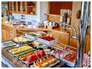 a buffet line with many different types of food at B & B Gurterhof in Schenna