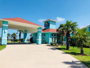 a large blue building with a clock on it at Days Inn by Wyndham Port Aransas TX in Port Aransas