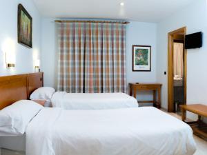 Ένα ή περισσότερα κρεβάτια σε δωμάτιο στο Hostal La Maya