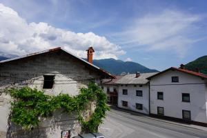 a group of buildings on a street with mountains at Apartma Irena Volče in Volzana