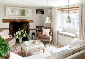 a living room with a couch and a fireplace at Moorland View Cottage in North Bovey