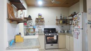 a kitchen with a stove and a refrigerator at Villa Celeste in Guayaquil