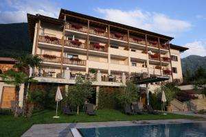 a hotel with a swimming pool and a resort at B & B Gurterhof in Schenna