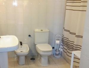a bathroom with a white toilet and a sink at Foz do Arelho Beach Apartment "Blue" in Foz do Arelho