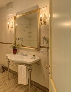 a bathroom with a sink and a mirror at La Vecchia Sassa in Montaione