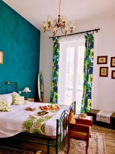 a bedroom with a bed with a blue wall at Pi Greco in Syracuse