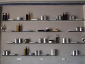 a wall with shelves filled with various items on it at Prodeo Hotel + Lounge in Buenos Aires