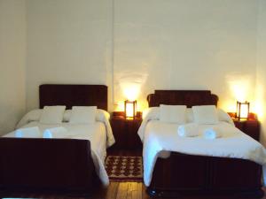 Un pat sau paturi într-o cameră la Hotel Hacienda El Aserrio