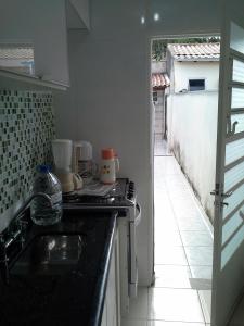 a kitchen with a sink and a counter top at Sobrado na Cidade de Socorro in Socorro