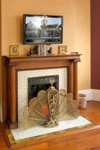 a fireplace with a television on top of it at The Artist House in Key West