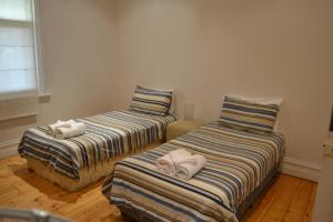 two beds with towels on them in a room at Tin House in Tanunda in Tanunda