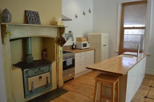 a kitchen with an old stove and a wooden table at Tin House in Tanunda in Tanunda