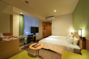 a hotel room with a bed and a desk at Candeo Hotels Nara Kashihara in Kashihara