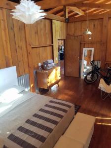 a bedroom with a bed and a table in a room at Casa Naturalis Iguazú in Puerto Iguazú +13 photos