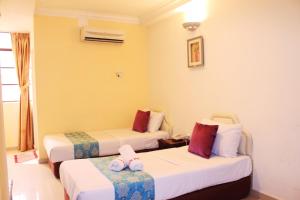 Postel nebo postele na pokoji v ubytování Sun Inns Hotel Puchong