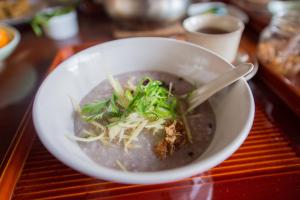 a bowl of soup on a red tray at Homestay at Remote Organic Farm in Nachikatsuura