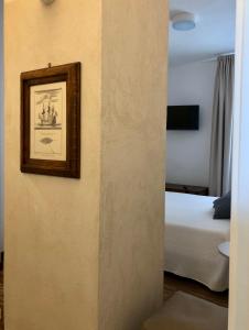 a hotel room with a bed and a mirror at B&B Mare di Fuori in Stintino
