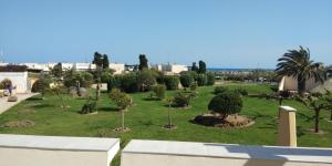 a park with trees and bushes on the grass at Zen et Summer Zen coursive naturiste in Cap d'Agde