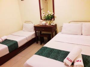 Postel nebo postele na pokoji v ubytování Sun Inns Hotel Puchong