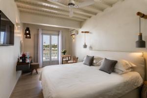 A bed or beds in a room at Poseidon Hotel Suites