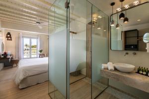 A bed or beds in a room at Poseidon Hotel Suites