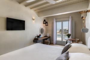 A bed or beds in a room at Poseidon Hotel Suites