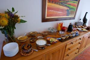 a table with food and bowls and plates on it at Golden Hill Guest House in Somerset West