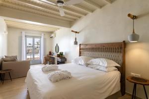 A bed or beds in a room at Poseidon Hotel Suites