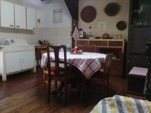 a kitchen with a table with a bowl of fruit on it at Doña Irene B & B in Rancagua +27 photos