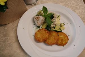 a plate of food with potatoes and vegetables on a table at Alpenhof Strenge in Birnbaum