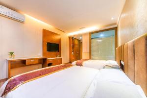 Postelja oz. postelje v sobi nastanitve Kaiserdom Hotel Baiyun Airport-24-hour Airport-Free shuttle bus