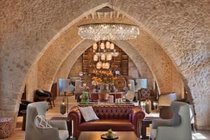 a wine tasting room with a chandelier in a stone building at The Setai Tel Aviv in Tel Aviv