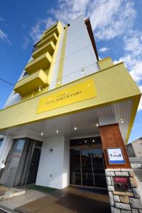 a building with a yellow and white building at Hotel Sakuranbo in Yamagata