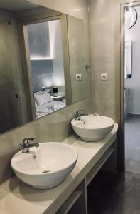 a bathroom with two sinks and a mirror at Lofos Strani in Zakynthos Town