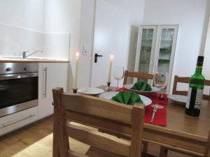 a dining room with a table with a bottle of wine at Downstairs6b in Dipperz