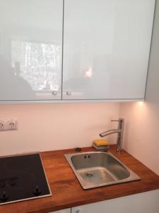 a kitchen with a sink and a counter top at RESET ul. Ratibora 66 in Jurata