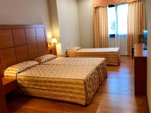 Postel nebo postele na pokoji v ubytování Hotel Grillo