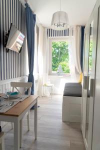 a living room with a table and a couch at Marina House Apartments in Międzyzdroje