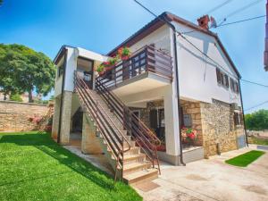 a house with stairs on the side of it at Apartmenst SLavica 1654 in Ližnjan