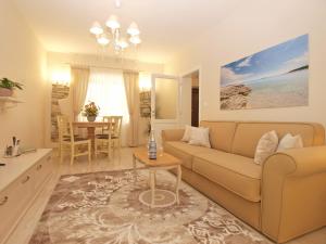 a living room with a couch and a table at Apartmenst SLavica 1654 in Ližnjan