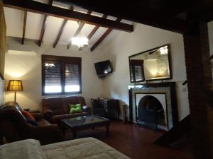a living room with a couch and a fireplace at Mi Naranjo (heated pool) in Orihuela Costa