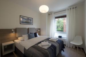 a bedroom with a bed with two hearts on it at Apartamenty Starówka - Riverside II in Szczecin