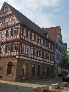 a building with a half timbered building at Quartier "Zur Alten Apotheke" in Brackenheim