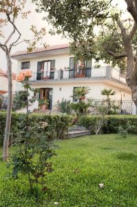 a large white house with a balcony at Villa Fraele in Acireale