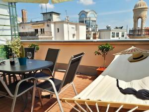 a patio with a table and chairs on a balcony at Rumbach Terrace Apartment in Budapest