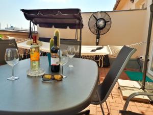 a table with wine bottles and glasses on a balcony at Rumbach Terrace Apartment in Budapest