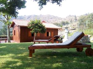 a hammock in the grass in front of a cabin at O Rincón de David in Cee