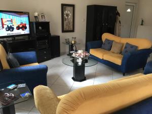 a living room with blue couches and a tv at Chalkida Beautiful Home with Stunning Views in Chalkida